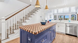 A kitchen with a checkered countertop, a built-in dishwasher, and a view to the outside. - Gorgeous Oceanfront Villa, Wild Dunes Resort. Phenomenal Views of Ocean and Community Pool, Unit 56 (Isle Of Palms)