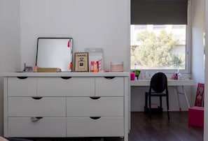 A room with a white dresser, a desk with a chair, - T4 apartment with incredible views! Sea view, route des sanguinaires (Ajaccio)