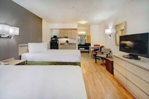 A hotel room with two beds, a TV, a desk, and a kitchenette. - Adventure-Ready Stay in Tucson Pet-Friendly w/ Pool + Free Parking Onsite (Tucson)