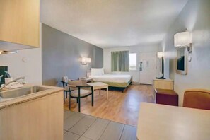 A compact hotel room with a kitchenette, a bed, a desk, and a chair. - Desert Escapade w/ Pool Access | 5.1 mi to Pima Air & Space Museum (Tucson)