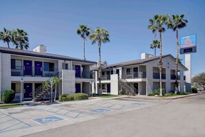 A motel with two-story buildings, palm trees, and a parking lot with handicapped accessibility. - Desert Escapade w/ Pool Access | 5.1 mi to Pima Air & Space Museum (Tucson)