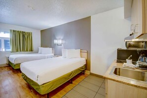A hotel room with two beds, a kitchenette, a window with curtains, and a wall-mounted light fixture. - 2 Units | Desert Adventure Retreat | 5.1 mi to Pima Museum (Tucson)