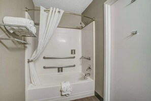 A bathroom with a bathtub, shower, and handrails. - Cactus Country Retreat w/ Free Parking+Pool | 4.3 mi to Reid Park Zoo | 2 Units (Tucson)