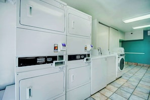A laundry facility with multiple washing machines and dryers, a control panel, and a tiled floor. - Cactus Country Retreat w/ Free Parking+Pool | 4.3 mi to Reid Park Zoo | 2 Units (Tucson)