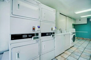 A laundry facility with multiple washing machines and dryers, a control panel, and a tiled floor. - Relaxing Stay w/ Pool and Parking Access | 4.7 mi to Hi Corbett Field (Tucson)