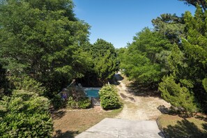 A backyard with a swimming pool surrounded by trees.