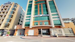 A modern hotel building with a prominent sign for 'Signature Hotel.' - Sig Al Barsha | Deluxe Room | Sheikh Zayed Rd, On-site Nightclubs, Salon (Dubai)
