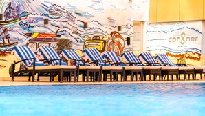 A pool area with lounge chairs and a mural depicting ocean scenes. - Mercure BH | 1BR Sky Apt | Spacious Living on Sheikh Zayed Rd | 2 Units (Dubai)