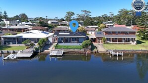 A residential area with houses, a dock, and a body of water.