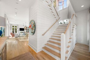A staircase with white railings and wooden steps leading to an upper level. - WaterColor w/ Private Pool, FirePit, 6 Bikes, & LSV/Golf Cart! (Santa Rosa Beach)