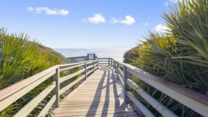 A wooden boardwalk leading to a beach with a clear sky and palm trees. - STEPS to Camp WaterColor! LSV/Golf Cart & 4 Bikes Included! (Santa Rosa Beach)