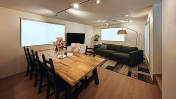 Deluxe Villa | Living area | 50-inch TV with digital channels