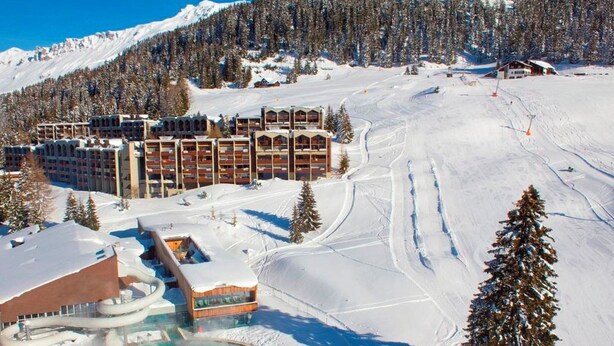 A ski resort with a large building complex, a snow-covered slope, and a pool area. - Soleval Tavanera 118 Moritz Appartement/Fewo,   5-Bettwohnung (3 Zimmerwohnung) by Interhome (Lenzerheide)