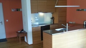 A modern kitchen with wooden cabinets, a dishwasher, and a stainless steel sink. - Clavo Vigl Appartement/Fewo Clavo Vigl by Interhome (Vaz)