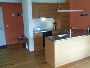 A modern kitchen with wooden cabinets, a dishwasher, and a stainless steel sink. - Clavo Vigl Appartement/Fewo Clavo Vigl by Interhome (Vaz)
