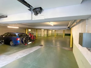 A parking garage with a blue car and a red bicycle. - Haus Montana 3/3 Appartement/Fewo,   4-Bettwohnung by Interhome (Lenzerheide)