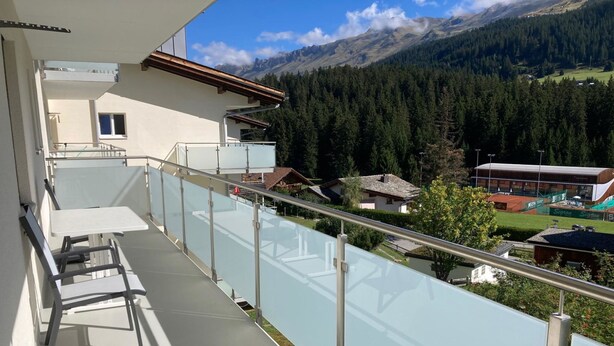 A balcony with a glass railing overlooking a mountainous landscape. - Haus Montana 3/4 Appartement/Fewo,   7-Bettwohnung by Interhome (Lenzerheide)