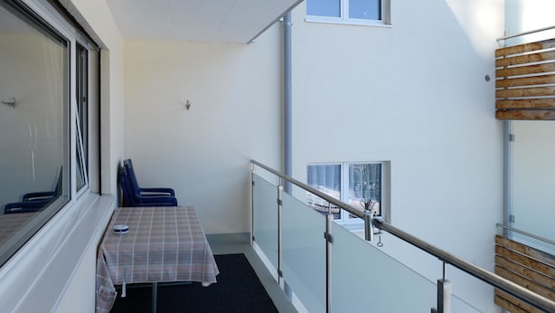 A balcony with a table and chairs, a railing, and a window. - Haus Montana 2/4 Appartement/Fewo,   4-Bettwohnung by Interhome (Lenzerheide)
