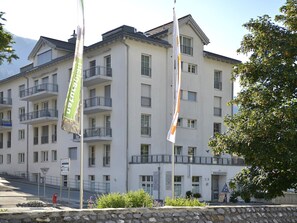 Ein mehrstöckiges Hotel mit Balkonen, einem Schild, das einen Parkplatz anzeigt, und einem Schild für ein Restaurant.