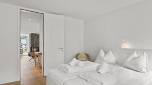 A hotel room with a large bed, a fireplace, and a view of the outside. - Triangel Raber Appartement/Fewo Triangel Raber by Interhome (Parpan)