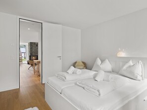 A hotel room with a large bed, a fireplace, and a view of the outside. - Triangel Raber Appartement/Fewo Triangel Raber by Interhome (Parpan)