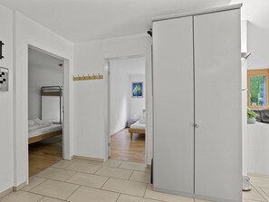 A modern bedroom with a bunk bed, a wardrobe, and a small bathroom. - Hemmadi Appartement/Fewo,   Ferienwohnung Hemmadi by Interhome (Churwalden)