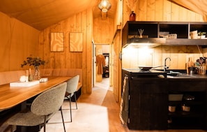 A wooden interior with a dining area, kitchen, and a hallway leading to a wardrobe. - Pet friendly home in Voorthuizen with WiFi (Voorthuizen)