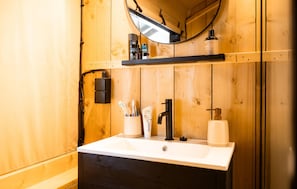 A wooden bathroom with a white sink, black faucet, and a mirror above. - Pet friendly home in Voorthuizen with WiFi (Voorthuizen)
