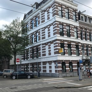 A multi-story building with a brick facade, a visible 'HOTEL' sign, and a 'P' parking sign. - Hotel Oosterpark (Amsterdam)