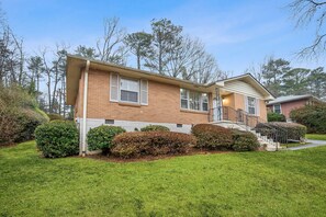 A two-story brick house with a front porch, a staircase, and a well-maintained lawn. - July 4th & FIFA Escape/ Cozy Decatur Home Near Downtown (Decatur)