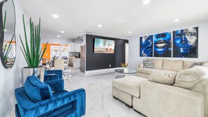 Een moderne woonkamer met een bank, een salontafel en een televisie.