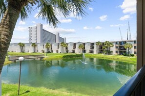 A hotel with a central courtyard, a fountain, and a bridge. - Steps to Beach, Pool, Pickleball & 3BR Sleeps 6 (Panama City Beach)