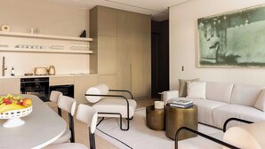A modern living room with a dining area, a sofa, and a kitchen in the background. - Luxury flat -2BR/6P-Madeleine/Saint Honore (Paris)