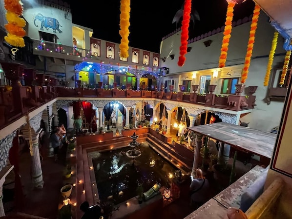 A courtyard with a fountain, seating areas, and decorative elements.