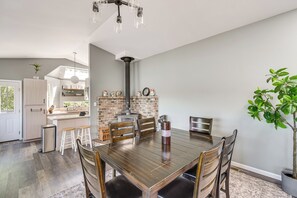 A dining area with a wooden table, chairs, and a potted plant. - Waterfront Union Getaway w/ Ocean & Mtn Views (Union)