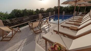 Seasonal outdoor pool, pool umbrellas, pool loungers