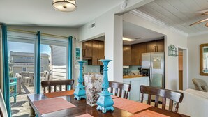 A dining area with a table, chairs, and decorative vases. - Red, White & Beach! 5BR Atlantic Beach Cottage (Atlantic Beach)