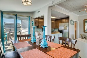 A dining area with a table, chairs, and decorative vases. - Red, White & Beach! 5BR Atlantic Beach Cottage (Atlantic Beach)