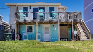 A two-story house with a balcony, a door, and a staircase leading to the upper level. - Red, White & Beach! 5BR Atlantic Beach Cottage (Atlantic Beach)