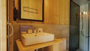 A wooden bathroom with a sink, toilet, and shower. - Holiday Home in Noord-scharwoude With Wi-fi (Noord-Scharwoude)