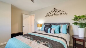 A bedroom with a bed, a ceiling fan, a wall-mounted decorative piece, and a potted plant. - Stylish Maricopa Cottage w/ Mtn Views & Grill! (Maricopa)
