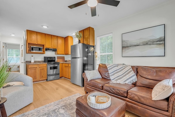 A modern kitchen with wooden cabinets, stainless steel appliances, and a large refrigerator.