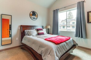 A bedroom with a bed, a window with curtains, a lamp, and a wall art piece. - Retreat with Indoor Swim Spa; Access to Clear Lake (Medical Lake)