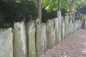 Eine Steinmauer mit einem Kiesweg daneben.