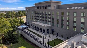 A modern hotel with a rooftop pool, outdoor seating, and a landscaped courtyard. - Hotel Vin, Rogers-Bentonville, Autograph Collection (Rogers)