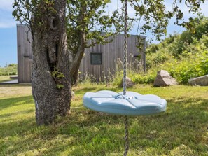 A tree with a swing hanging from a rope. - 4 Star Holiday Home in Allinge (Allinge)