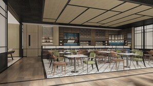 A modern restaurant with a high ceiling, wooden flooring, and a mix of green and brown chairs. - Four Points by Sheraton Shenzhen Nanshan (Shenzhen)