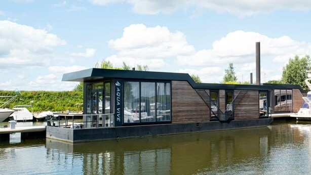 A modern floating structure with a glass facade, wooden accents, and a staircase leading to an upper deck. - Holiday Home in Olburgen With Terrace (Olburgen)