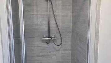 Combined shower/bathtub, deep-soaking bathtub, towels