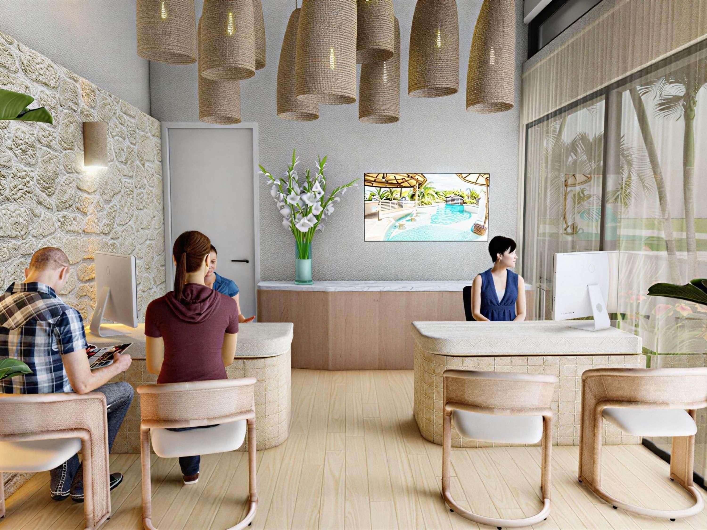 A modern reception area with a stone wall, a reception desk, and a large window with a view of palm trees.
